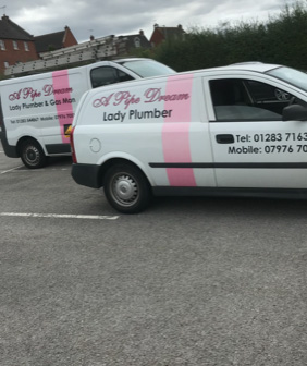 pink and white lady plumbers van and gas man van parked in a car park